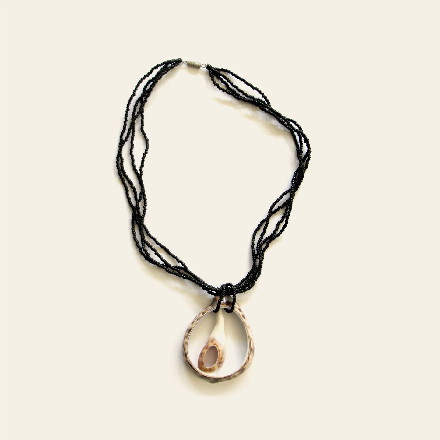 Handmade necklace with a duo of open shell pendants on black seed bead strands — Nayabijou.