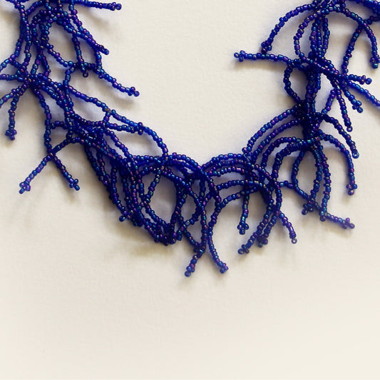 Close-up of the blue glass beaded coral-style necklace details