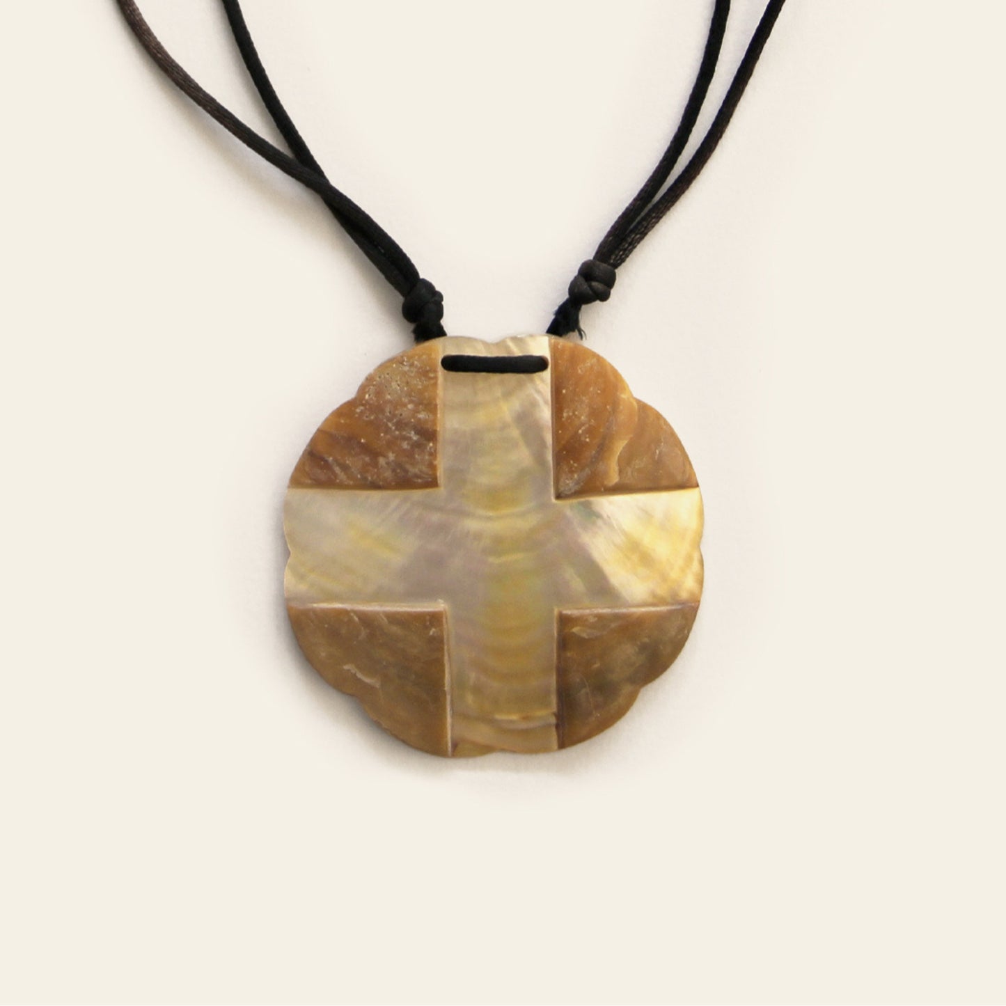 Closeup of handmade mother of pearl pendant necklace with black cotton cord – Nayabijou