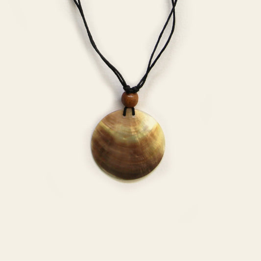 Closeup of handmade necklace with black cord and round natural Mother of Pearl pendant – Nayabijou.