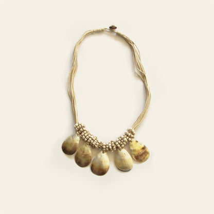 Natural sand-colored teardrop shell necklace with layered black cord and artisanal accents- Nayabijou
