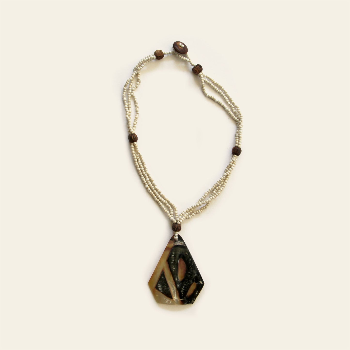 Handmade necklace with triangular mother of pearl shell pendant and beaded strands – Nayabijou.