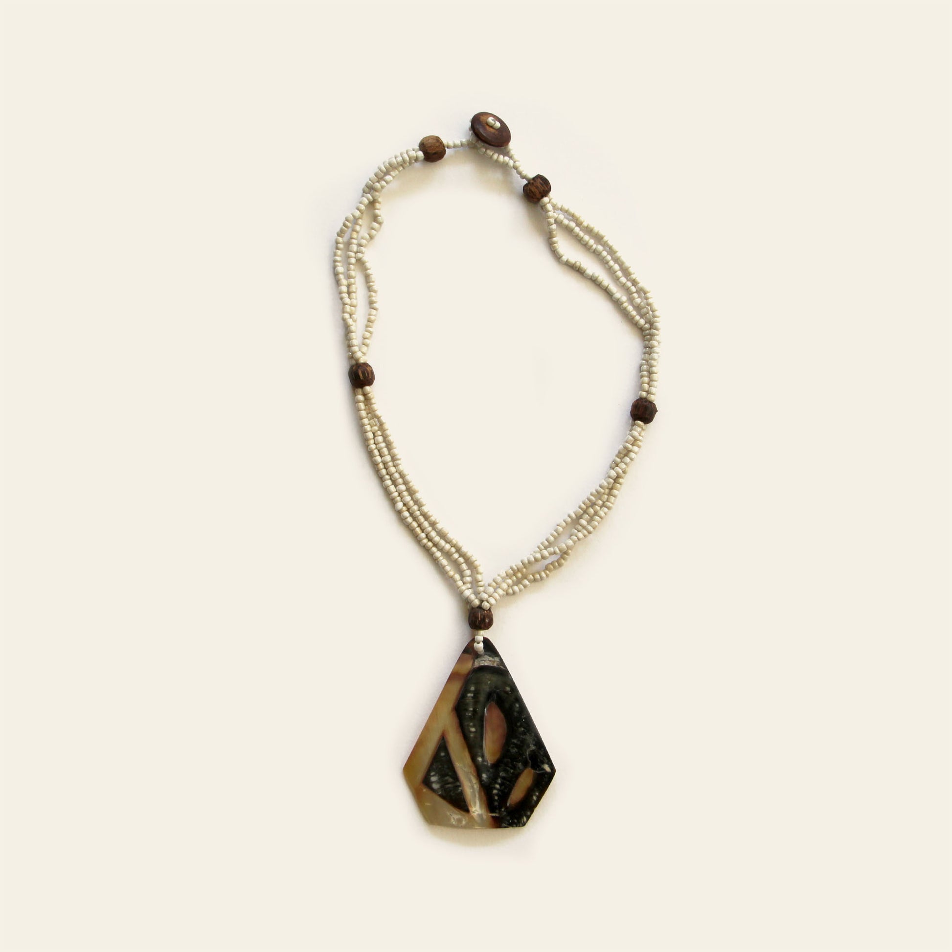 Handmade necklace with triangular mother of pearl shell pendant and beaded strands – Nayabijou.