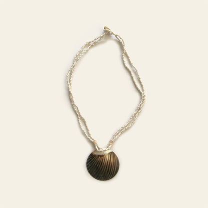 Handmade necklace with white seed beads and a dark scallop shell pendant – Nayabijou.