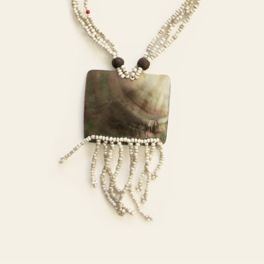 Close-up of rectangular shell pendant with ivory fringe and beaded strands – Nayabijou.