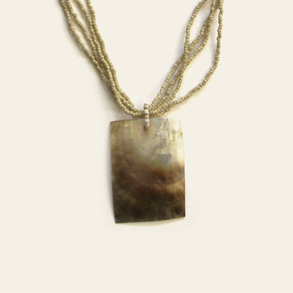 Closeup of rectangular mother-of-pearl pendant necklace with beige seed beads – Nayabijou.