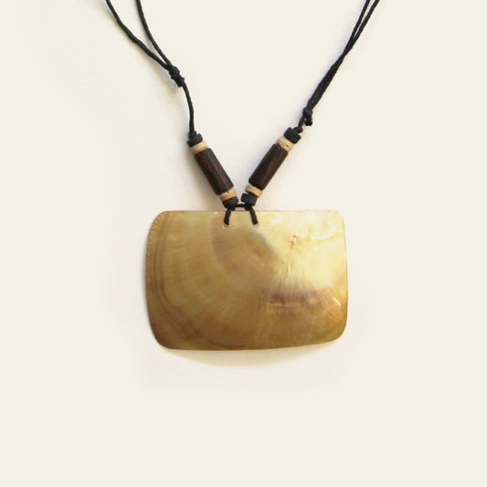 Close-up of curved mother-of-pearl pendant with wooden bead detail – Nayabijou.